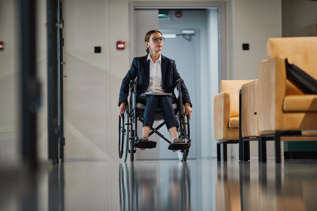 Businesswoman using wheelchair arriving to an event.