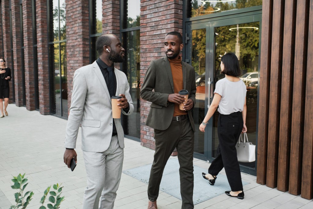 Colleagues Walking During Coffee Break