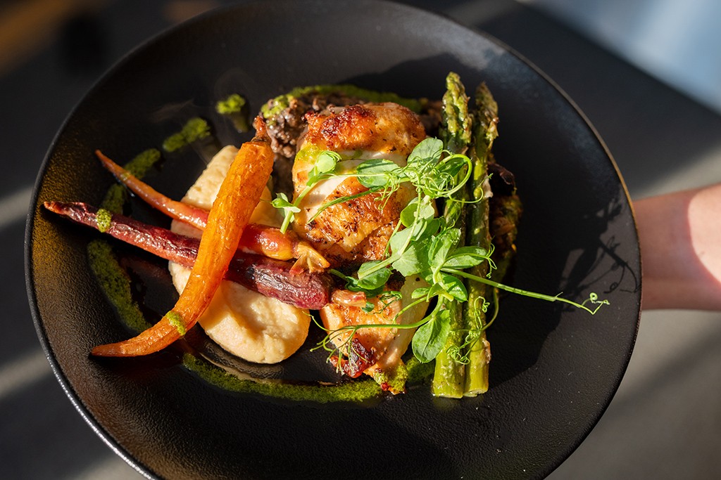 a beautifully plated meal of chicken and grilled vegetables