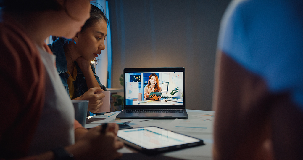 businesswomen using laptop talk to colleagues about plan in video call meeting at home office.