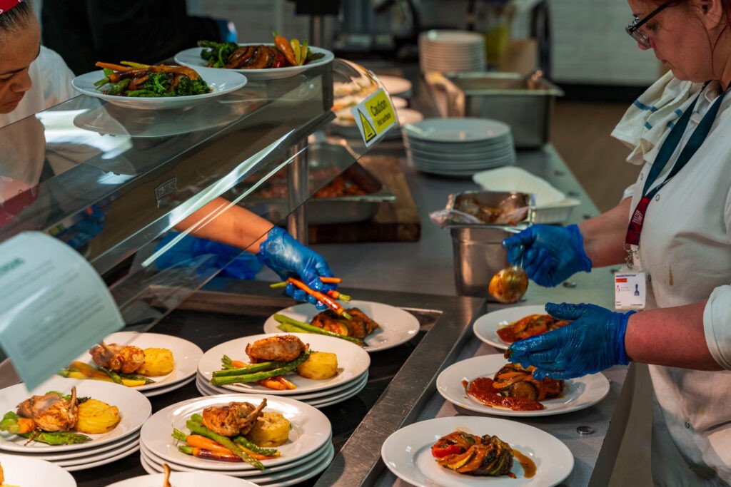 BaxterStorey catering team plating both meat and vegan options