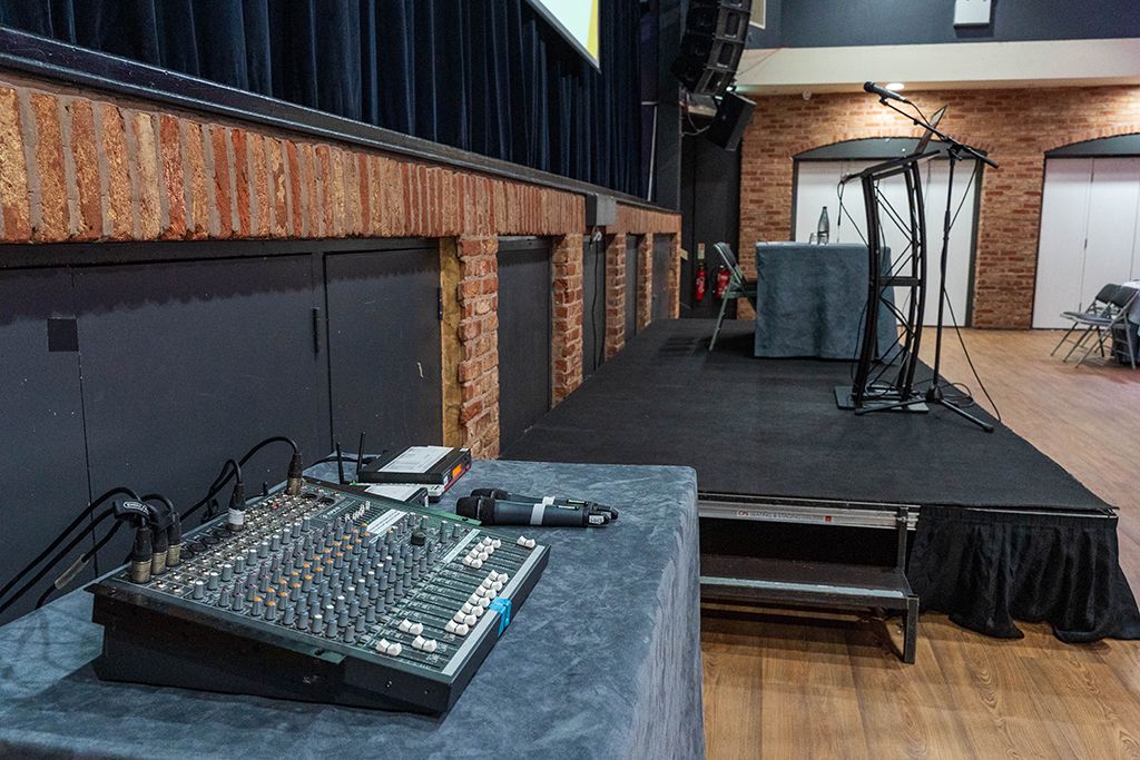 Venue 1 with audio equipment and podium with mic on substage