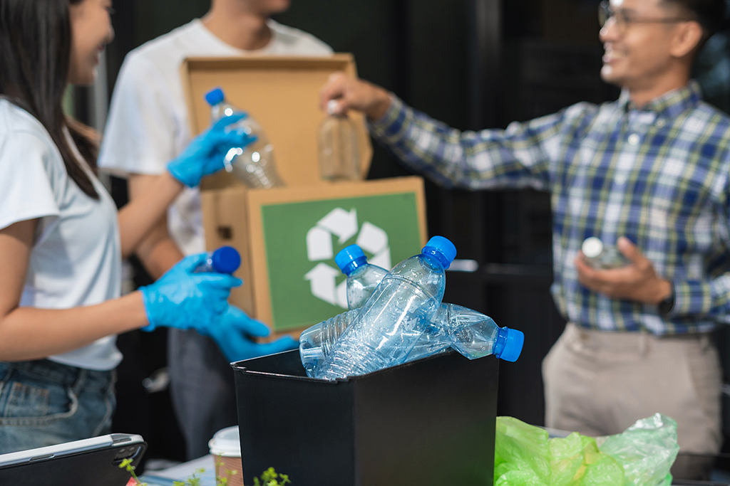 Business people working examining waste recyclable separation divided bin in the office, Sustainable development and innovation green business concept.