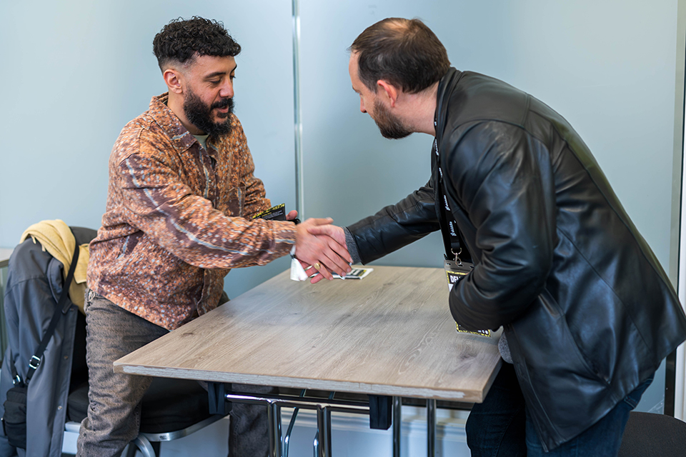 Attendees shaking hands in the Fitzrovia at an ISH Venues event.