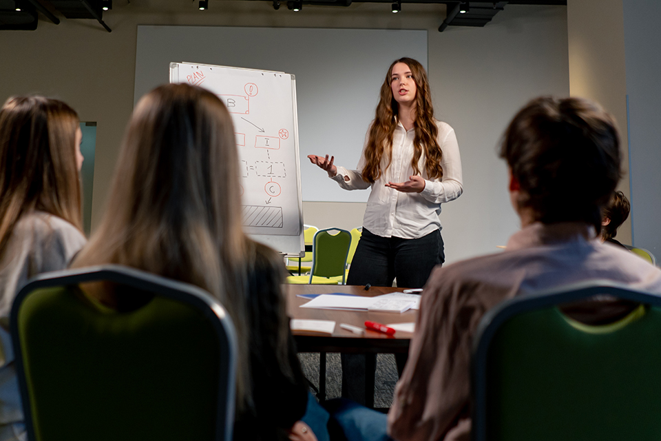 business conference or meeting at the hotel the girl on the flipchart shows the development plan for company