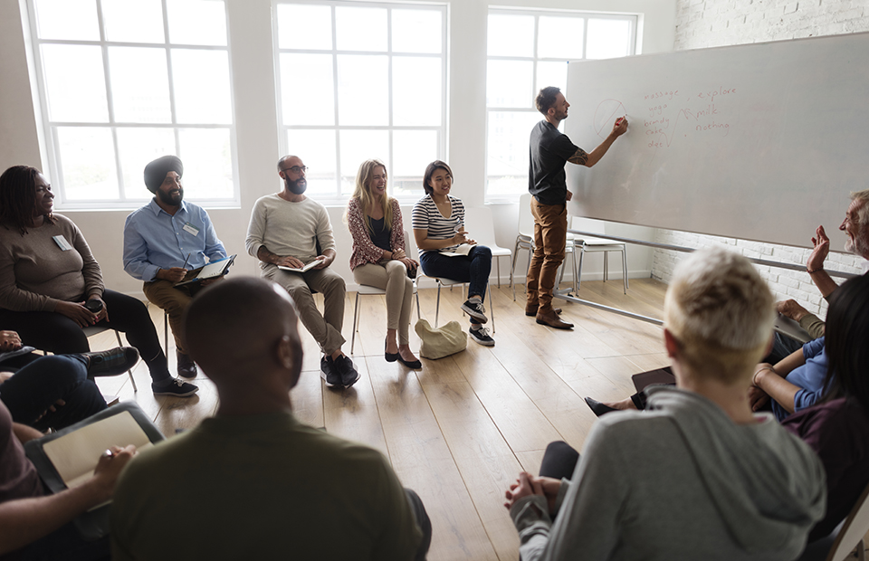 Man presenting at an in-person workshop.